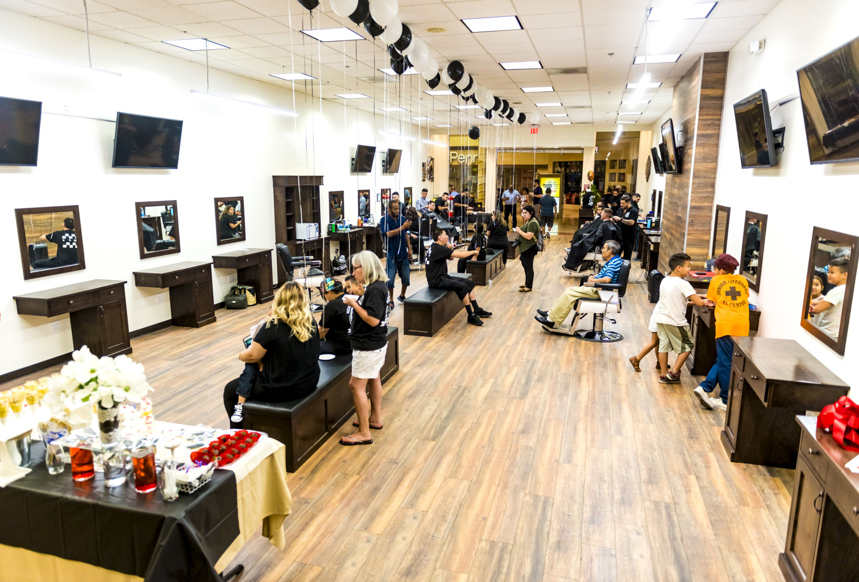 Headquarters Barbershop celebrated the grand opening of their new, larger location inside the Imperial Valley Mall